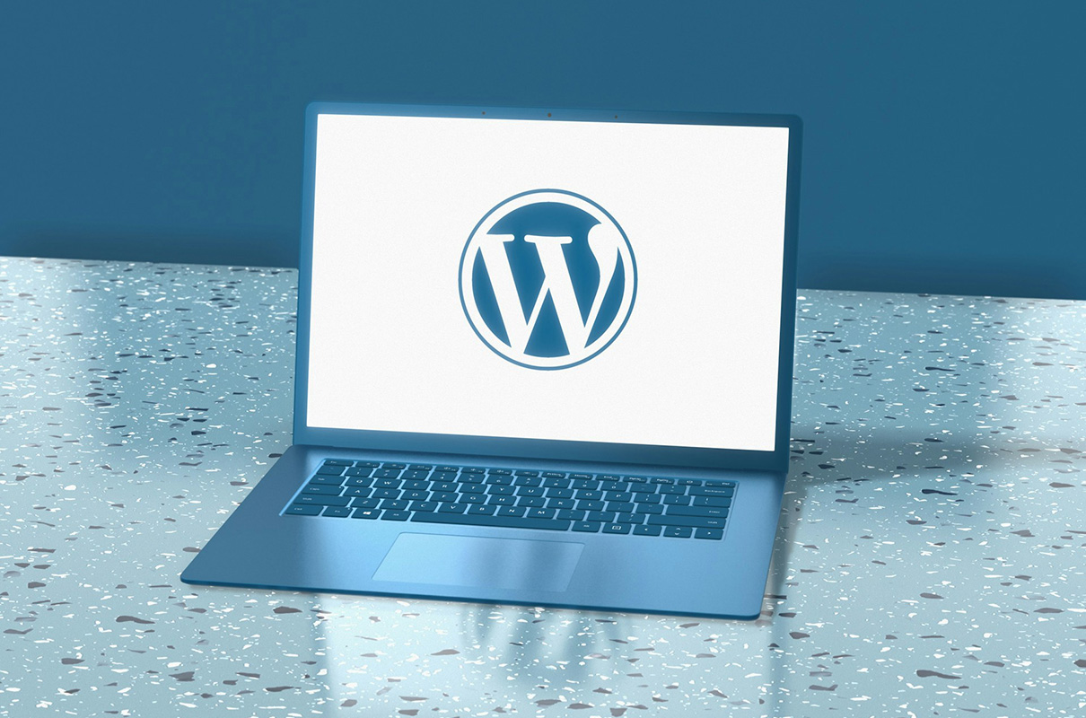 A laptop displaying the WordPress logo