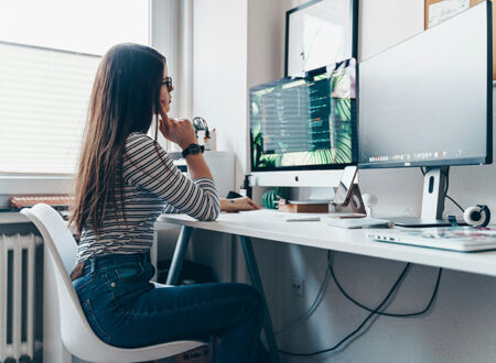 A person sitting at their computer desk.