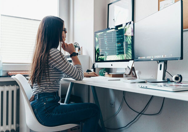 A person sitting at their computer desk.