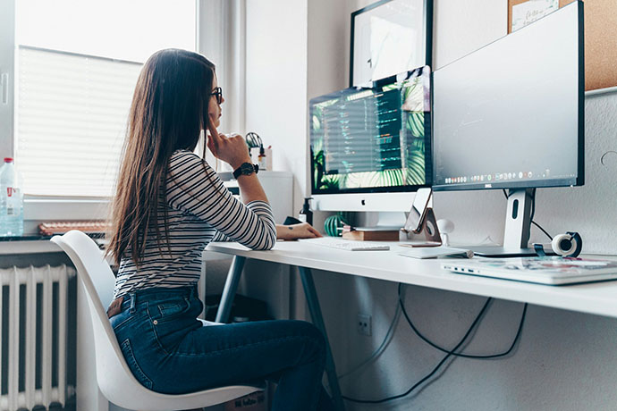 A person sitting at their computer desk.